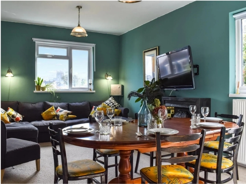 Photo of a teal and yellow coloured, vintage style dining room 