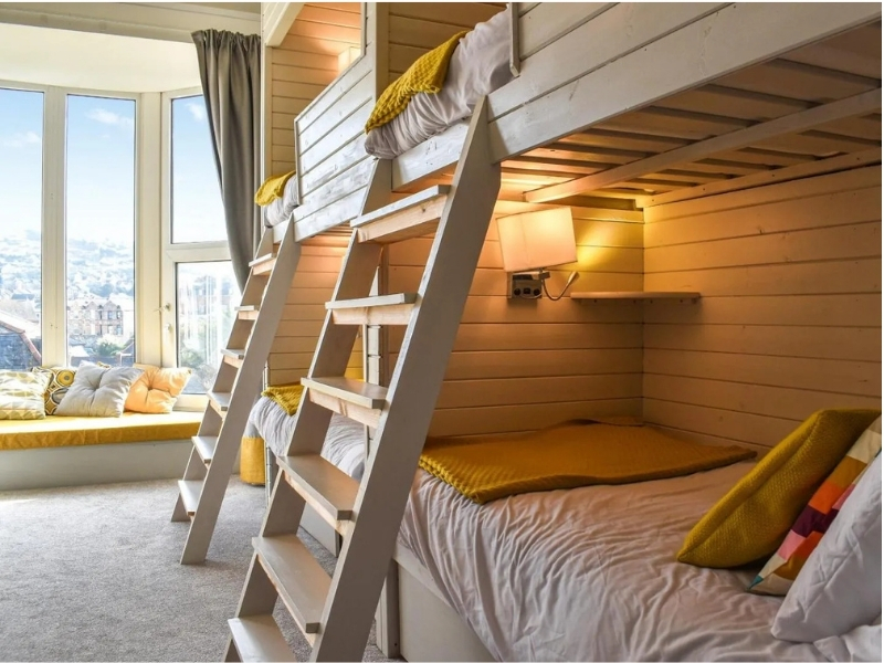 Cosy bunk beds in yellow and grey textile furnishings